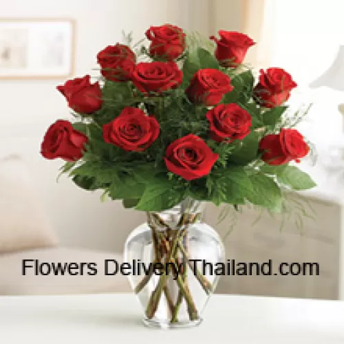 12 Red Roses With Some Ferns In A Glass Vase