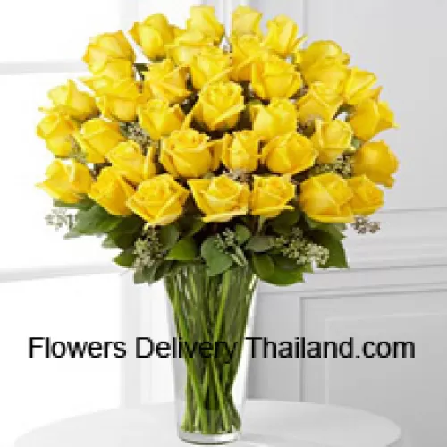36 Yellow Roses With Some Ferns In A Glass Vase