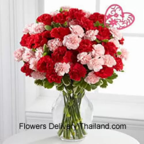 37 Carnations ( 18 Red And 18 Pink ) With Seasonal Fillers And Heart Stick In A Glass Vase